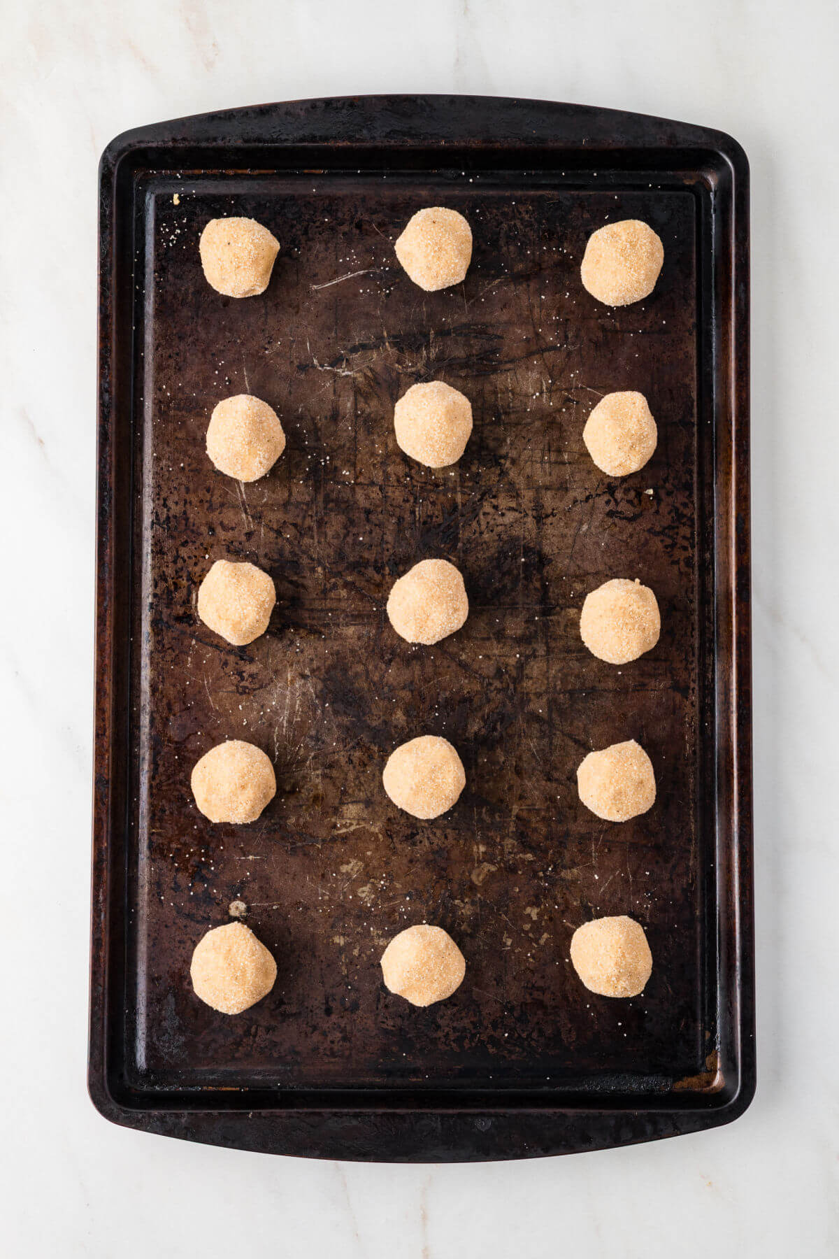 Cookie sheet with pumpkin pie spice cookie balls ready to bake.