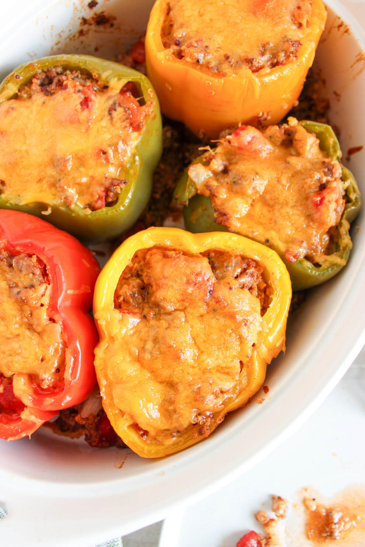 Quinoa stuffed peppers in a baking dish.