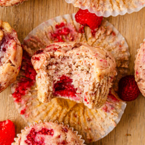 Raspberry ricotta muffins on a wooden table.