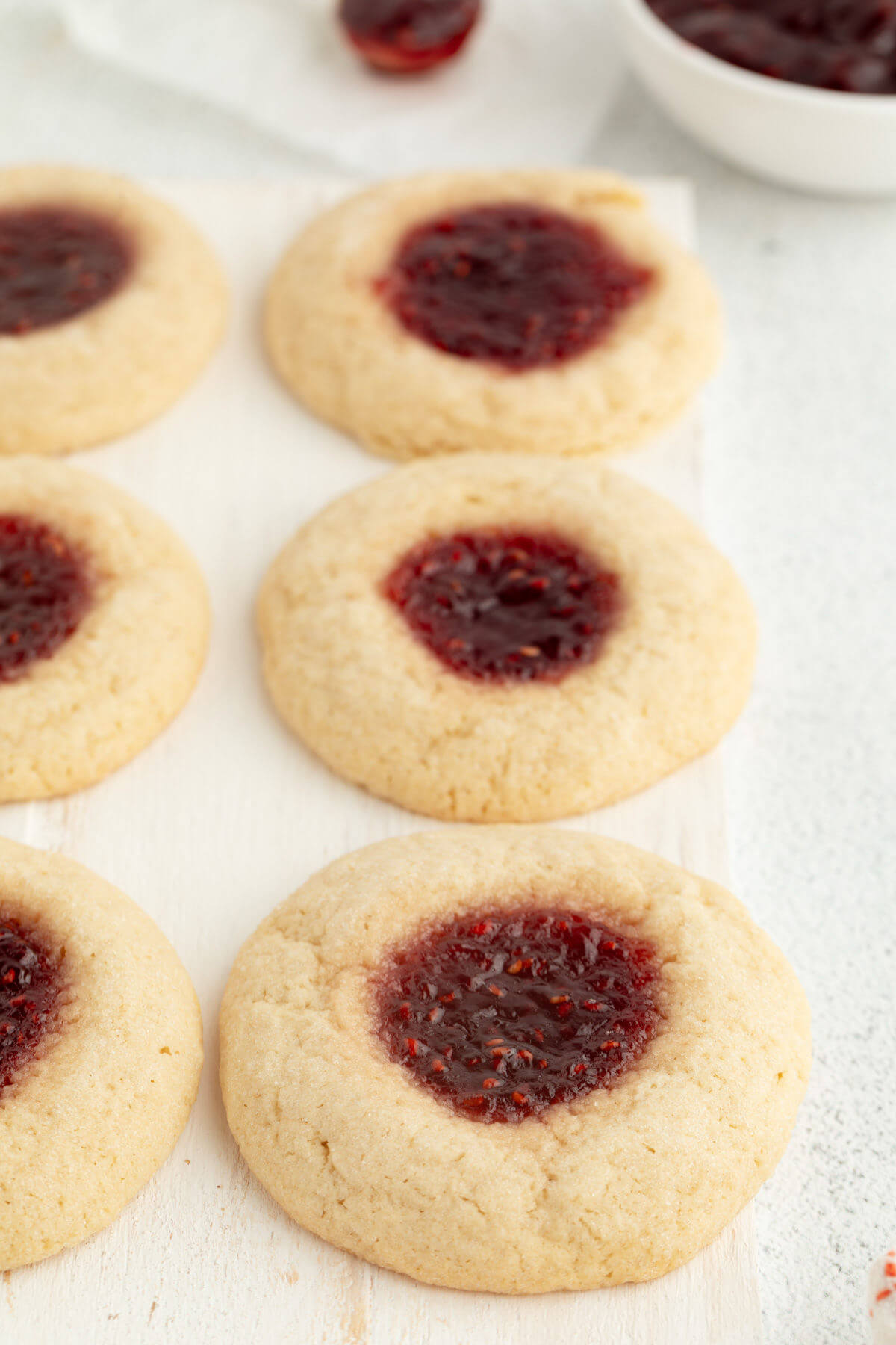 Sourdough thumbprint cookies on a white tray.