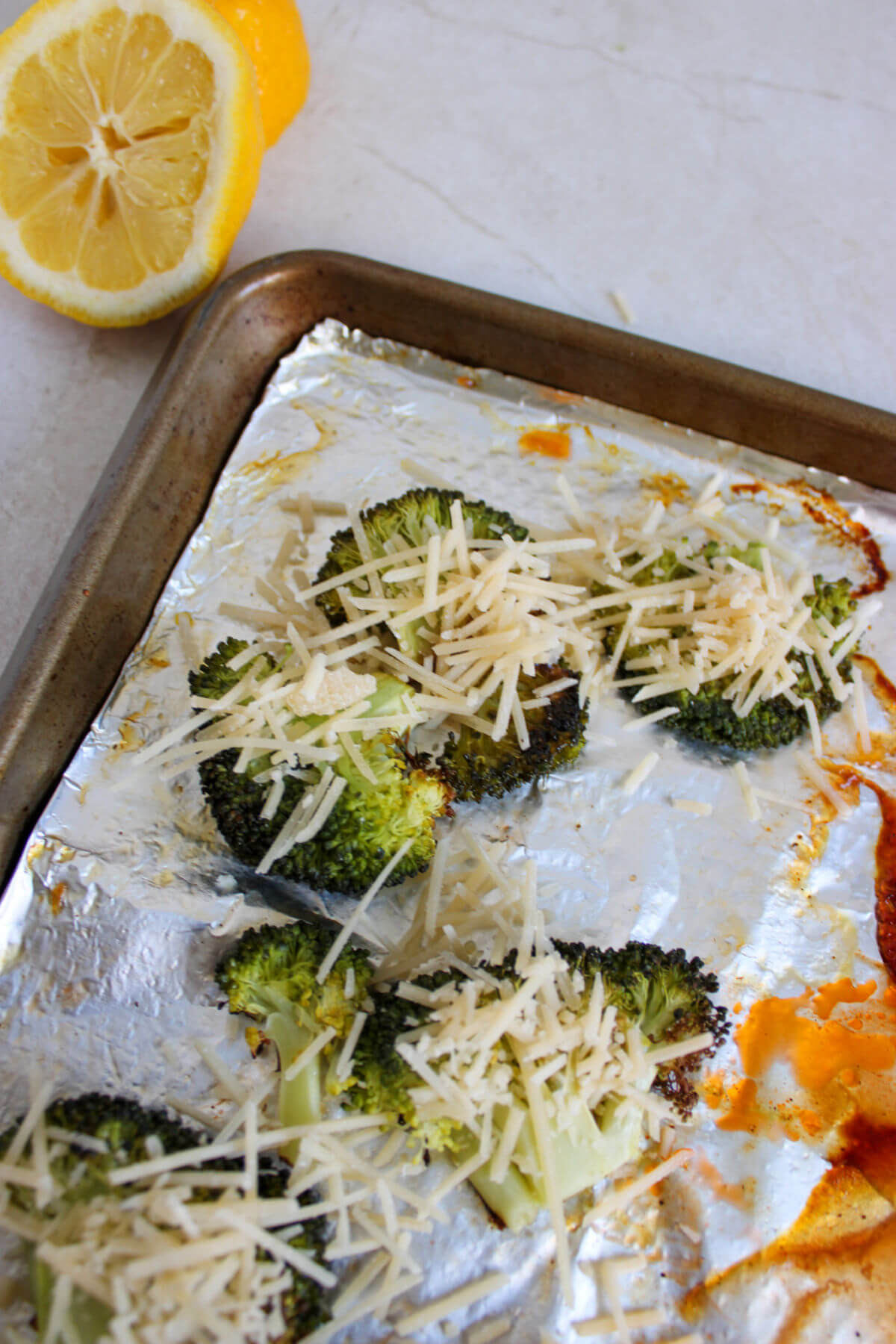 Cooking broccoli florets on a sheet pan.