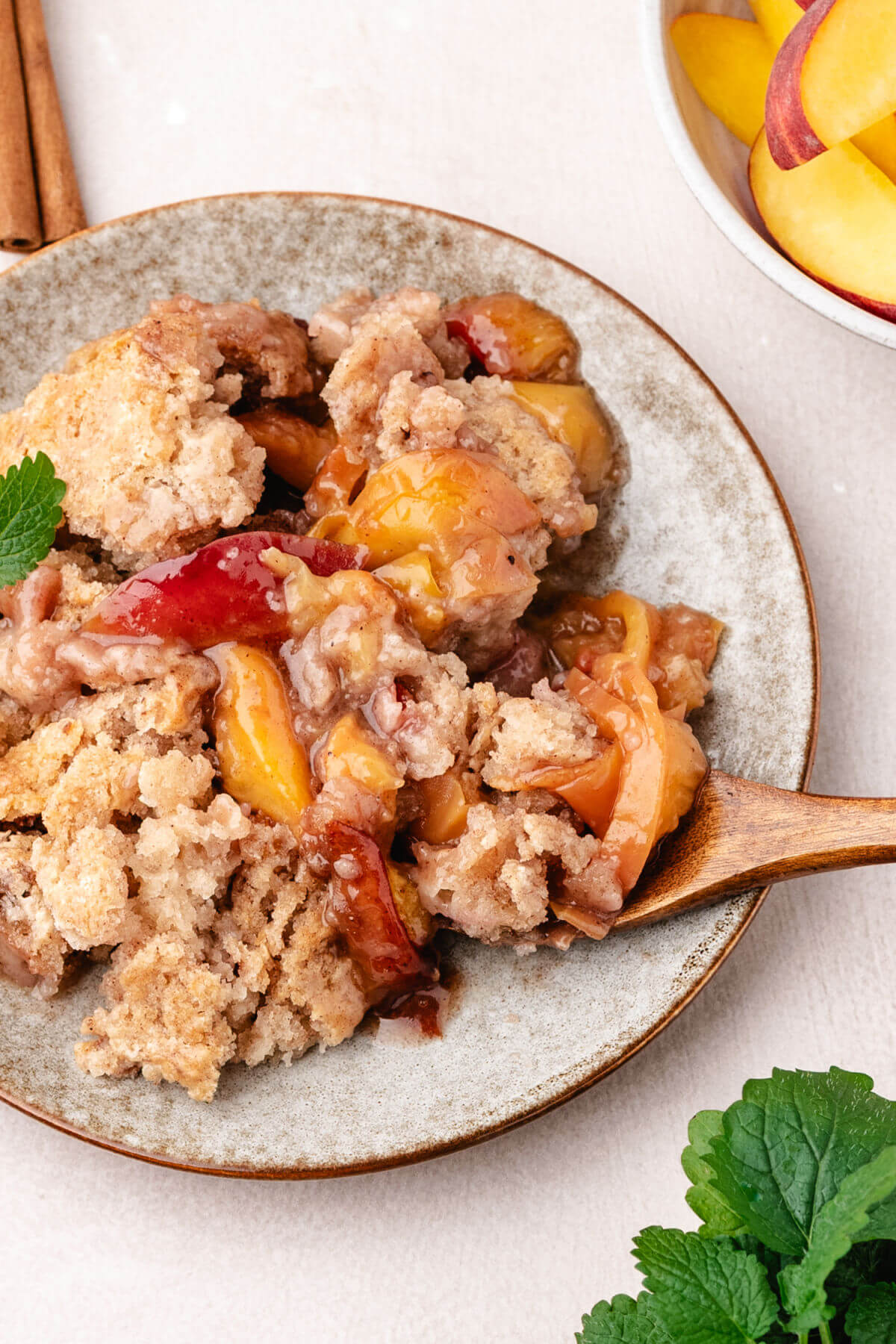 Skillet peach cobbler on a plate for serving.