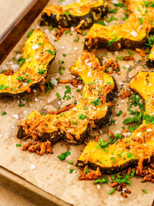 Roasted acorn squash on a baking sheet after baking.