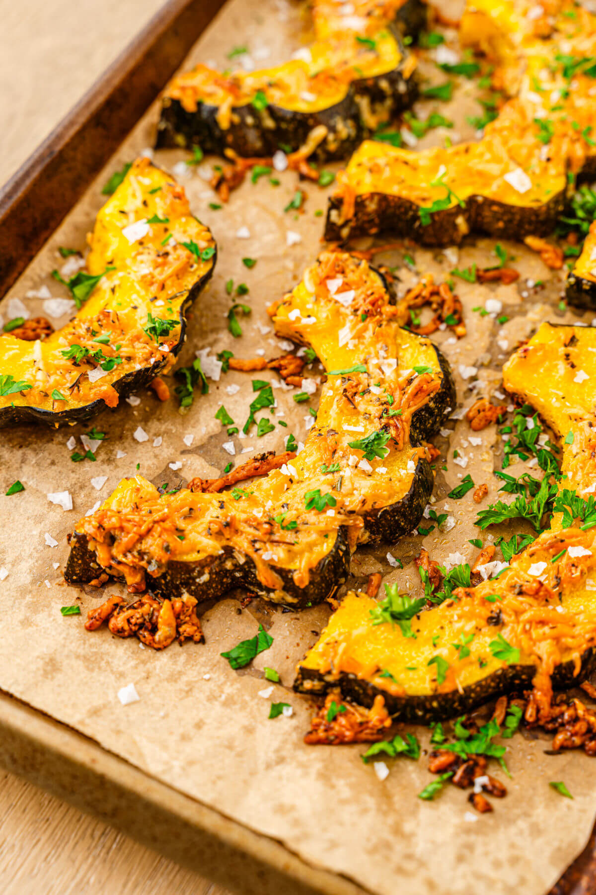 Roasted acorn squash on a baking sheet after baking.