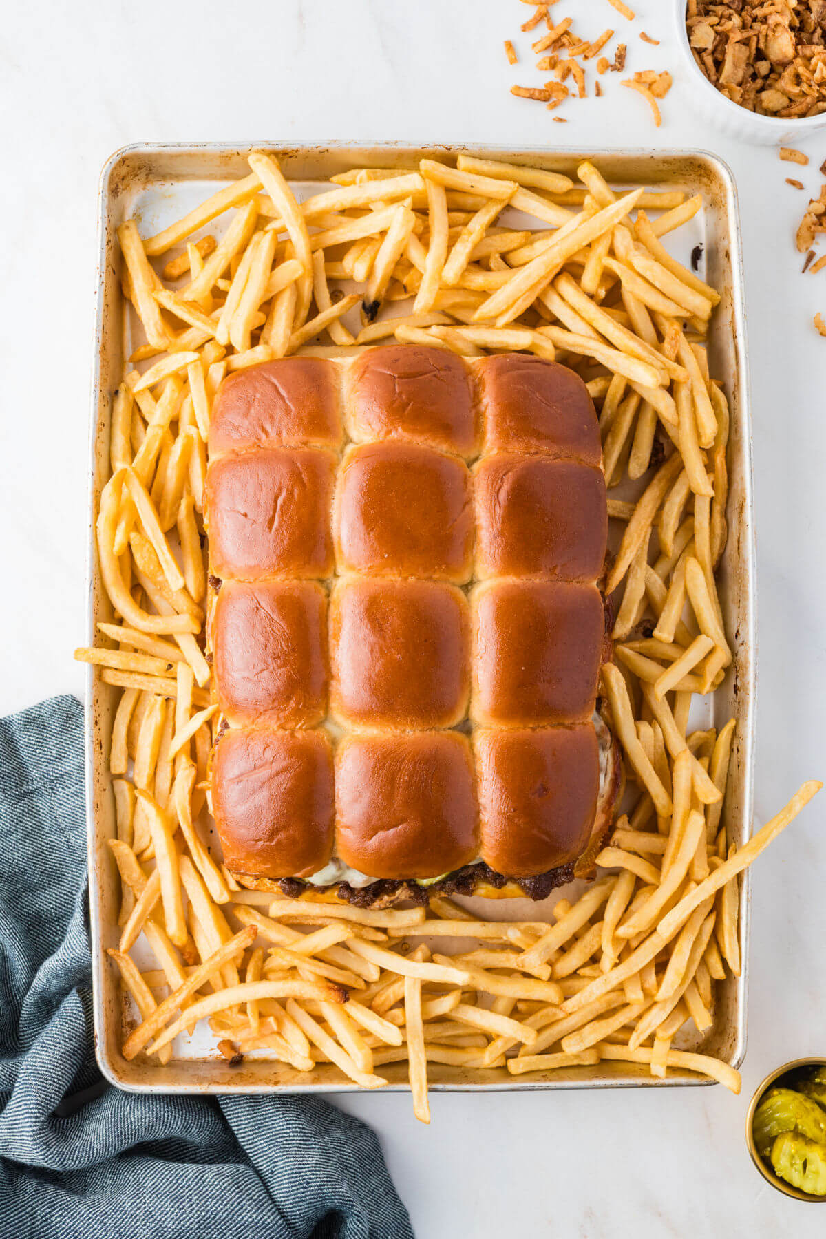 Baking tray with sloppy joe sliders after baking with sliders and french fries.