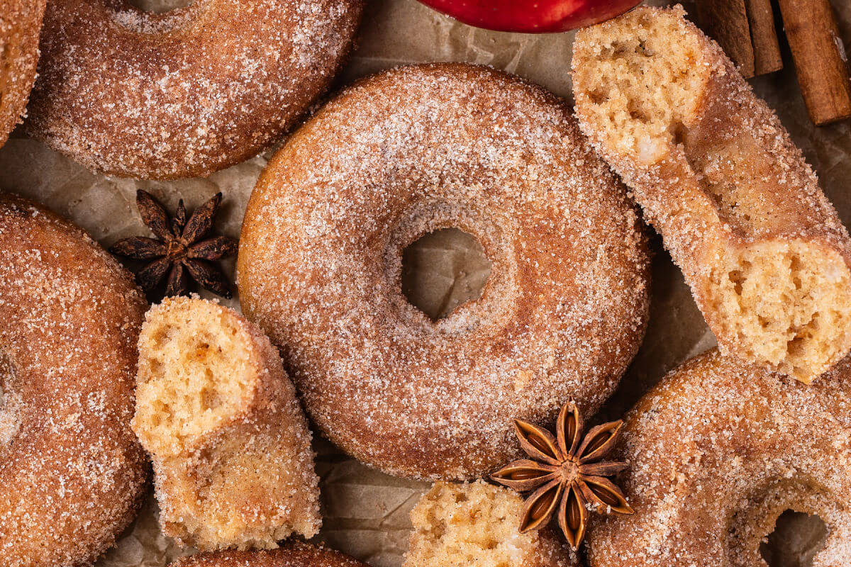 Sourdough apple cider donuts on parchment paper.