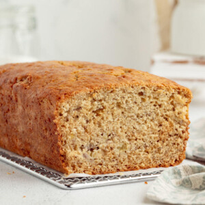 Sourdough banana bread loaf on a cooling rack.
