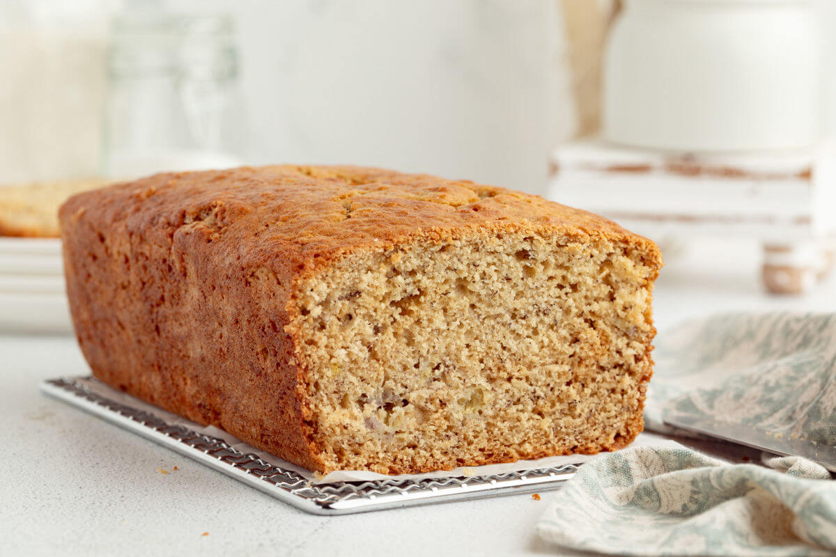 Sourdough banana bread loaf on a cooling rack.