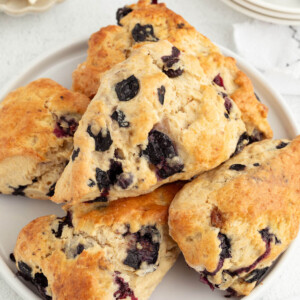 Sliced sourdough blueberry scones piled on a plate.
