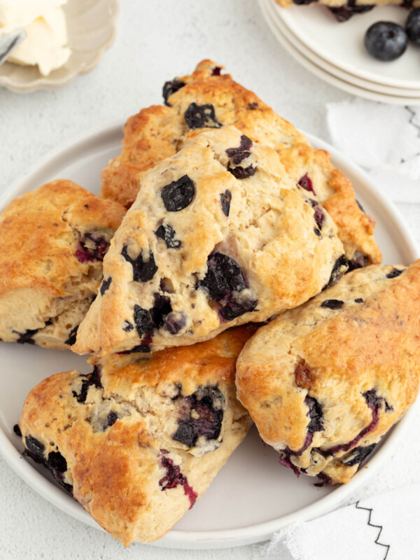 Sliced sourdough blueberry scones piled on a plate.