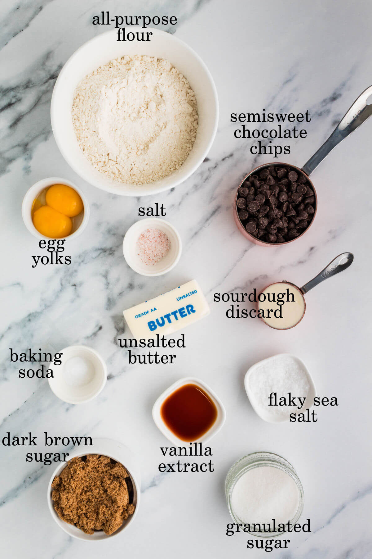 Ingredients for brown butter sourdough chocolate chip cookies in small bowls.