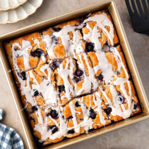 Blueberry sourdough butter swim biscuits in a square baking pan.