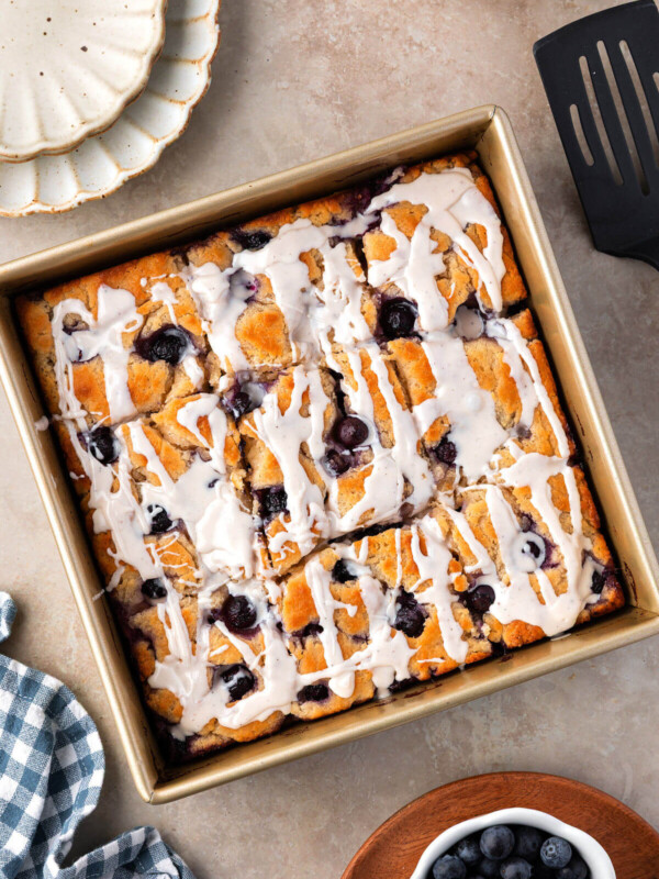 Blueberry sourdough butter swim biscuits in a square baking pan.