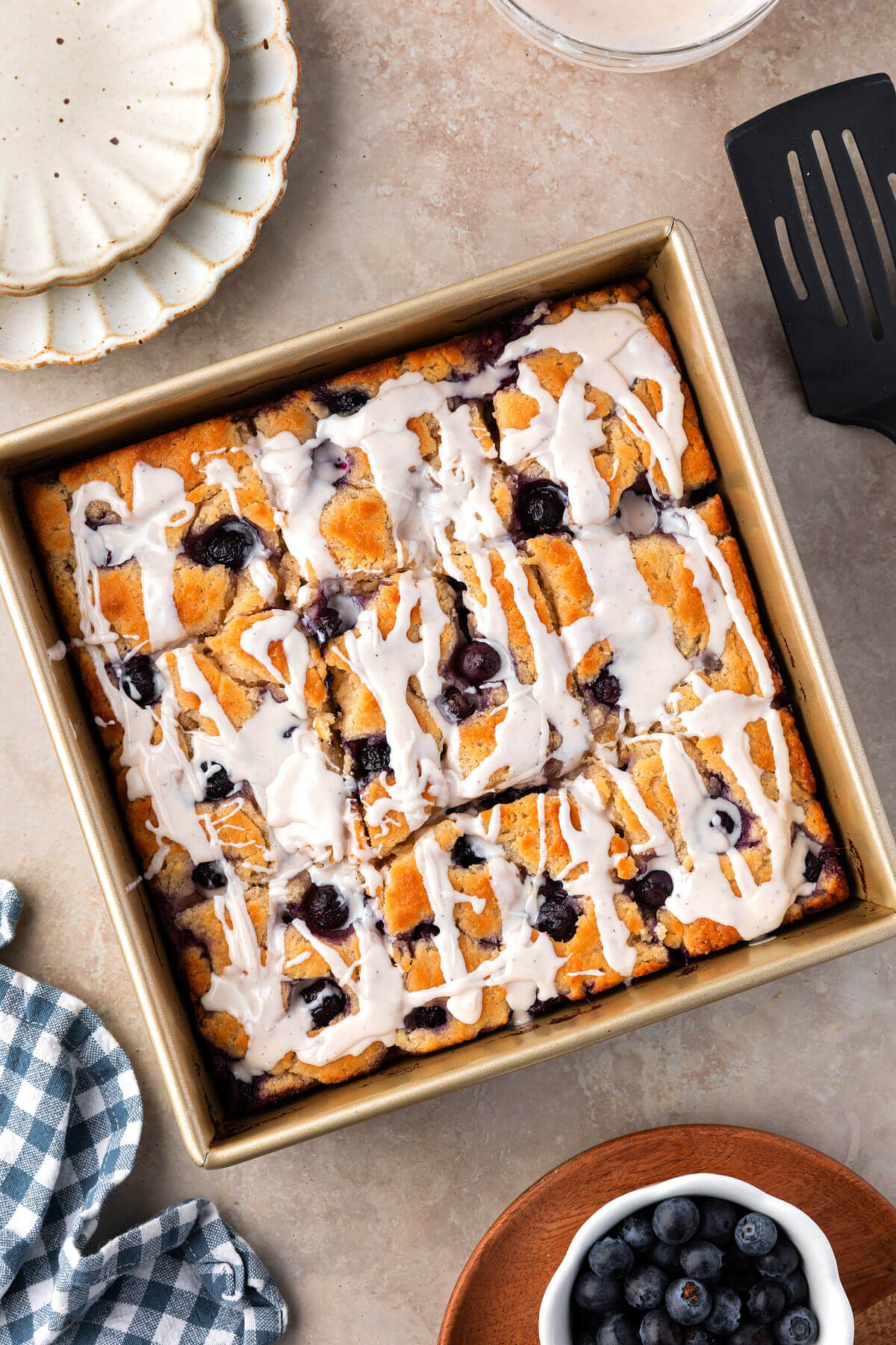 Blueberry sourdough butter swim biscuits in a square baking pan.
