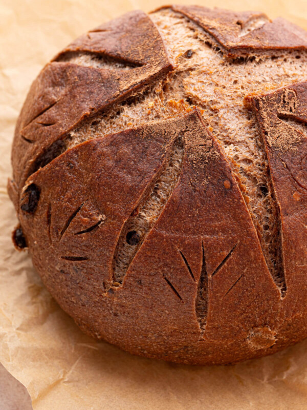Loaf of sourdough chocolate chili bread on a piece of parchment paper.
