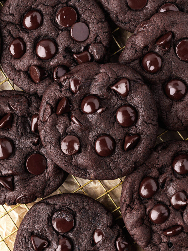 Sourdough chocolate cookies on a parchment-lined baking sheet.