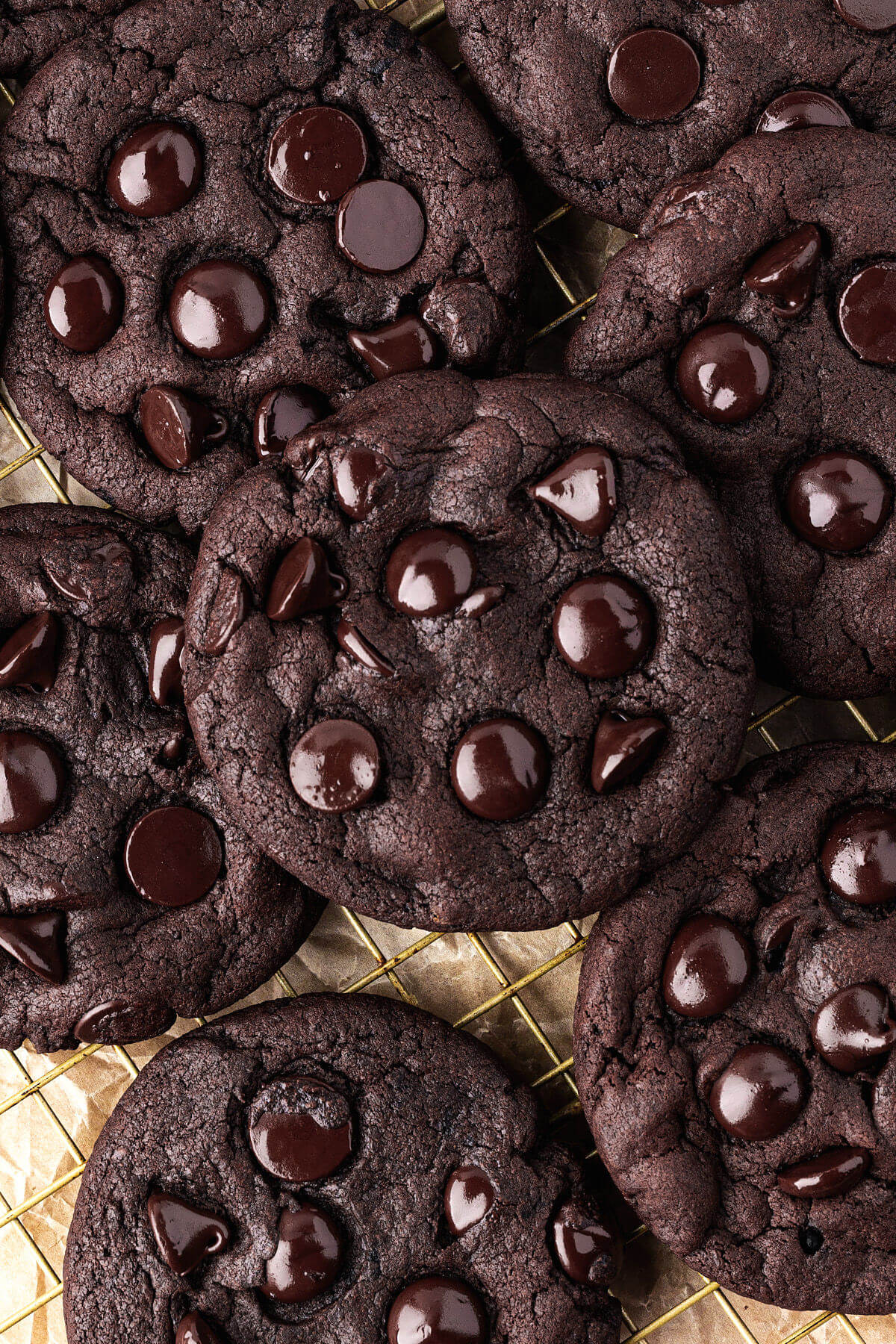 Sourdough chocolate cookies on a parchment-lined baking sheet.