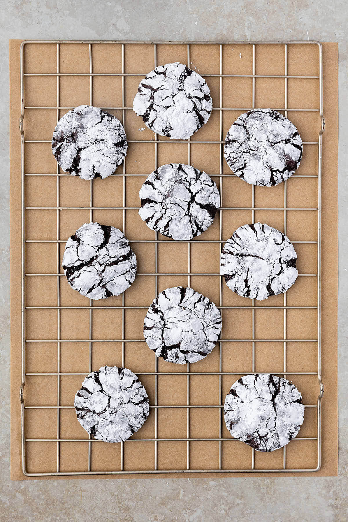 Sourdough chocolate crinkle cookies cooling on a wire rack.