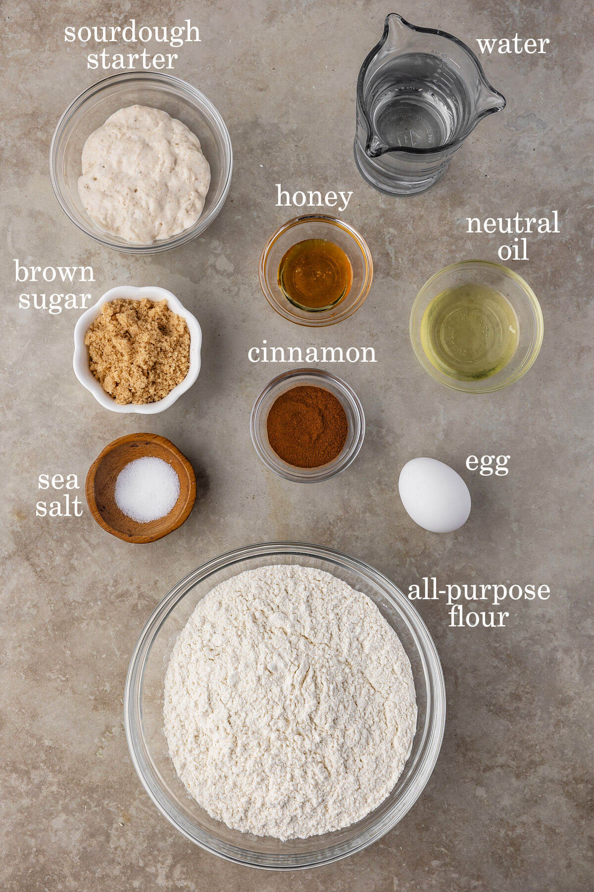 Ingredients for sourdough cinnamon swirl bread in small bowls.