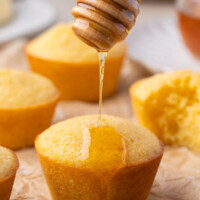 Sourdough cornbread muffins drizzled with honey.