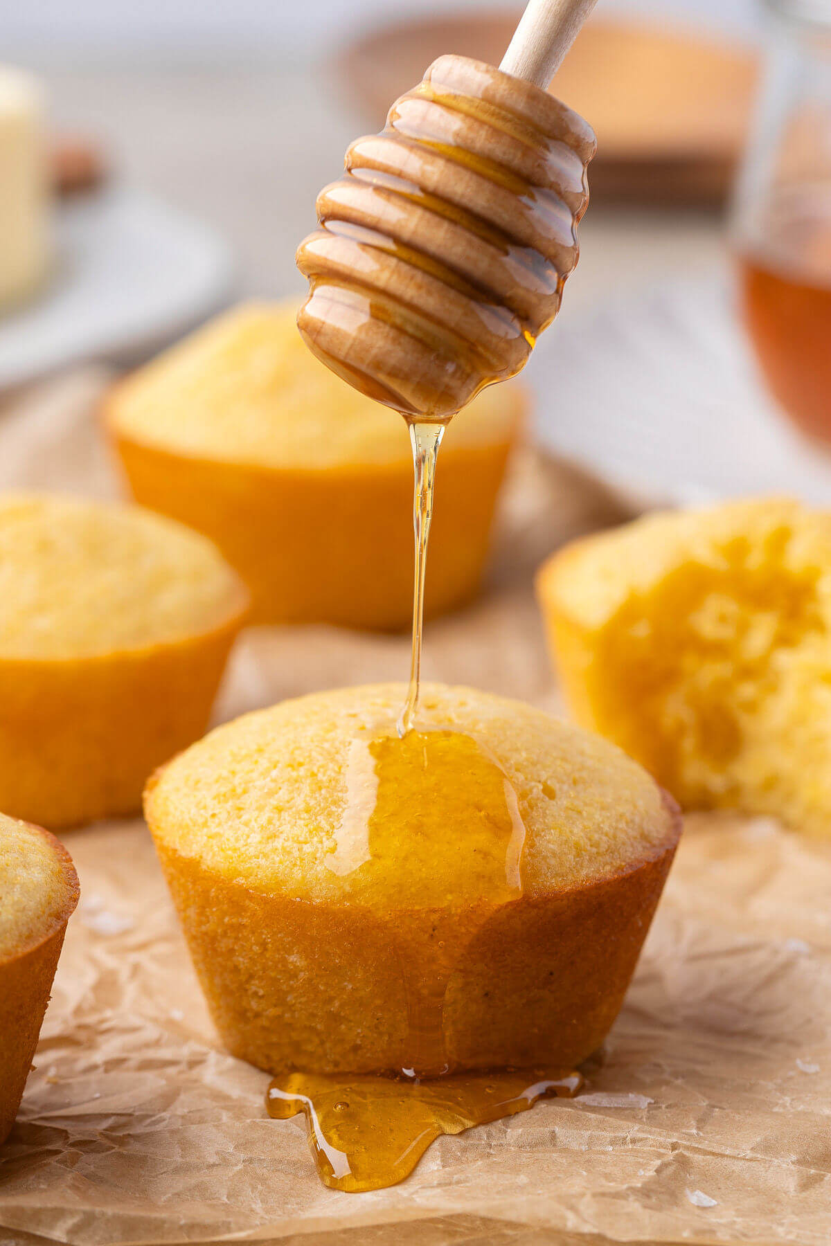 Sourdough cornbread muffins drizzled with honey.