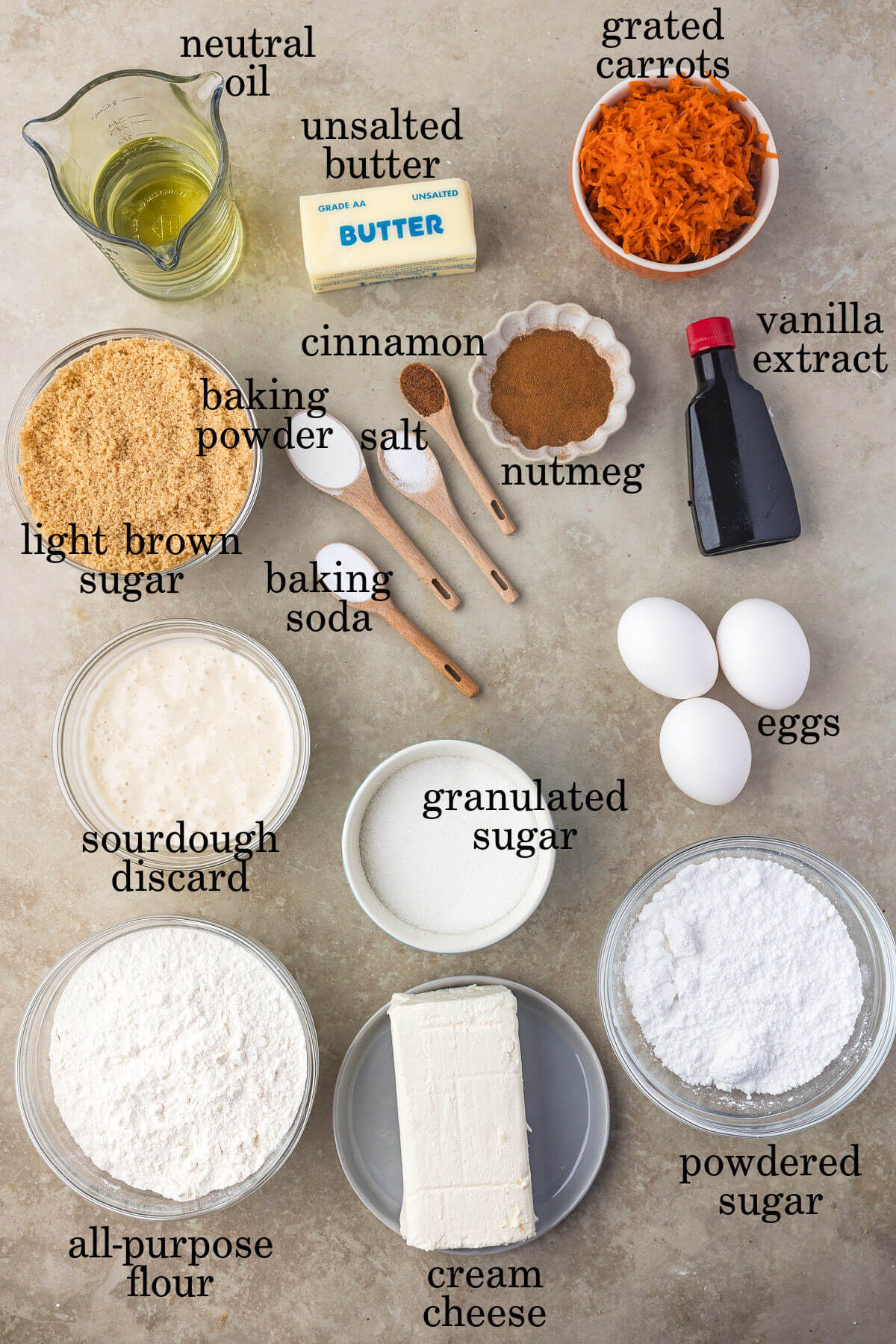 Ingredients for sourdough carrot cake bars in small bowls.