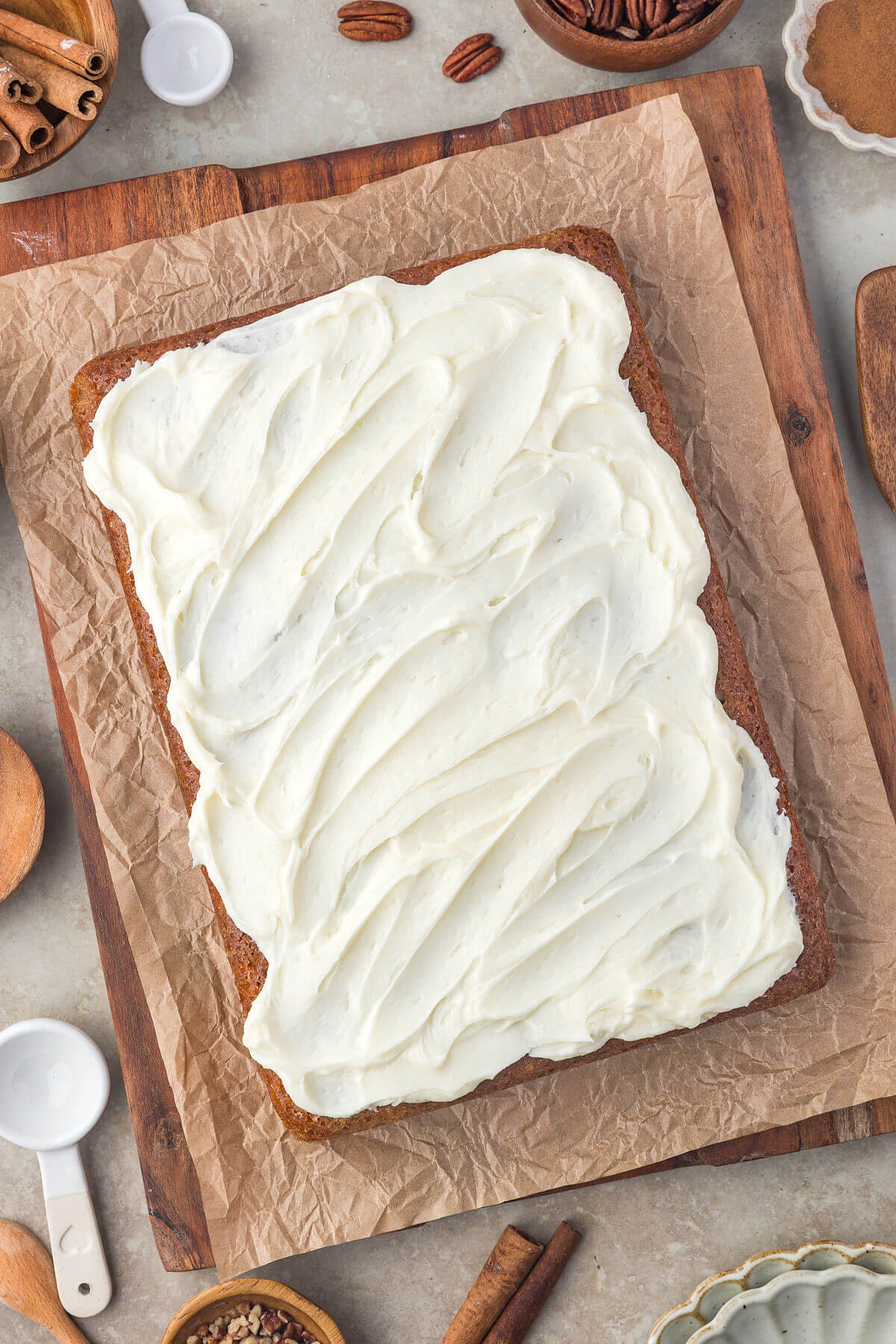 Spreading frosting on sourdough carrot cake bars.