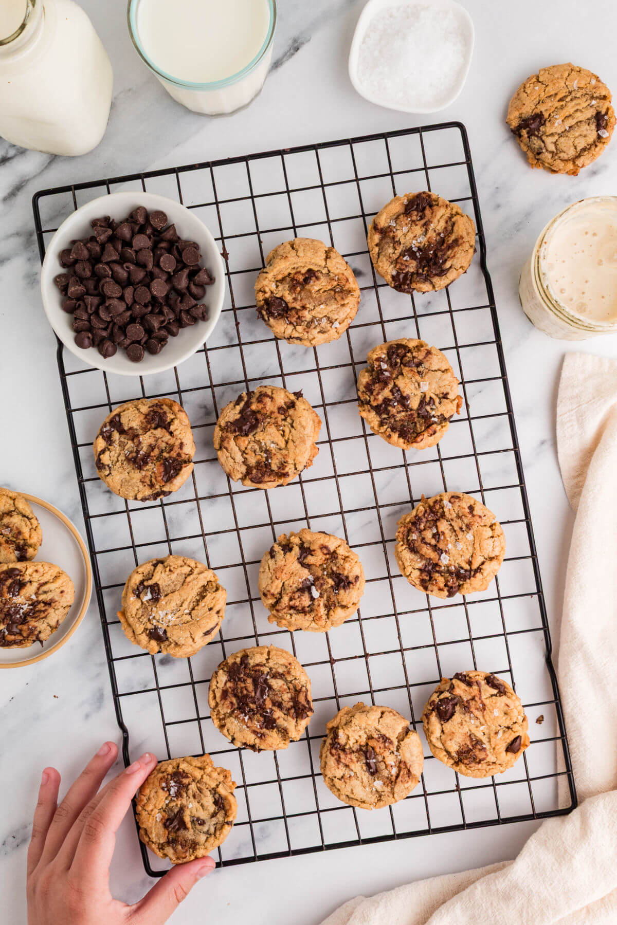 Brown butter sourdough chocolate chip cookies on a wire cooling rack after baking.