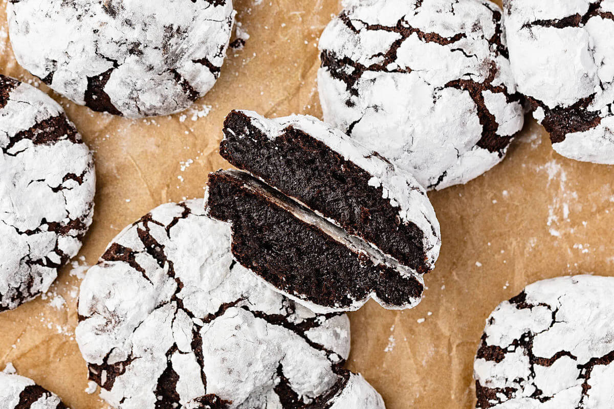 Sourdough chocolate crinkle cookies on a piece of parchment paper.
