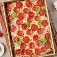 Sourdough discard focaccia pizza in a baking dish.