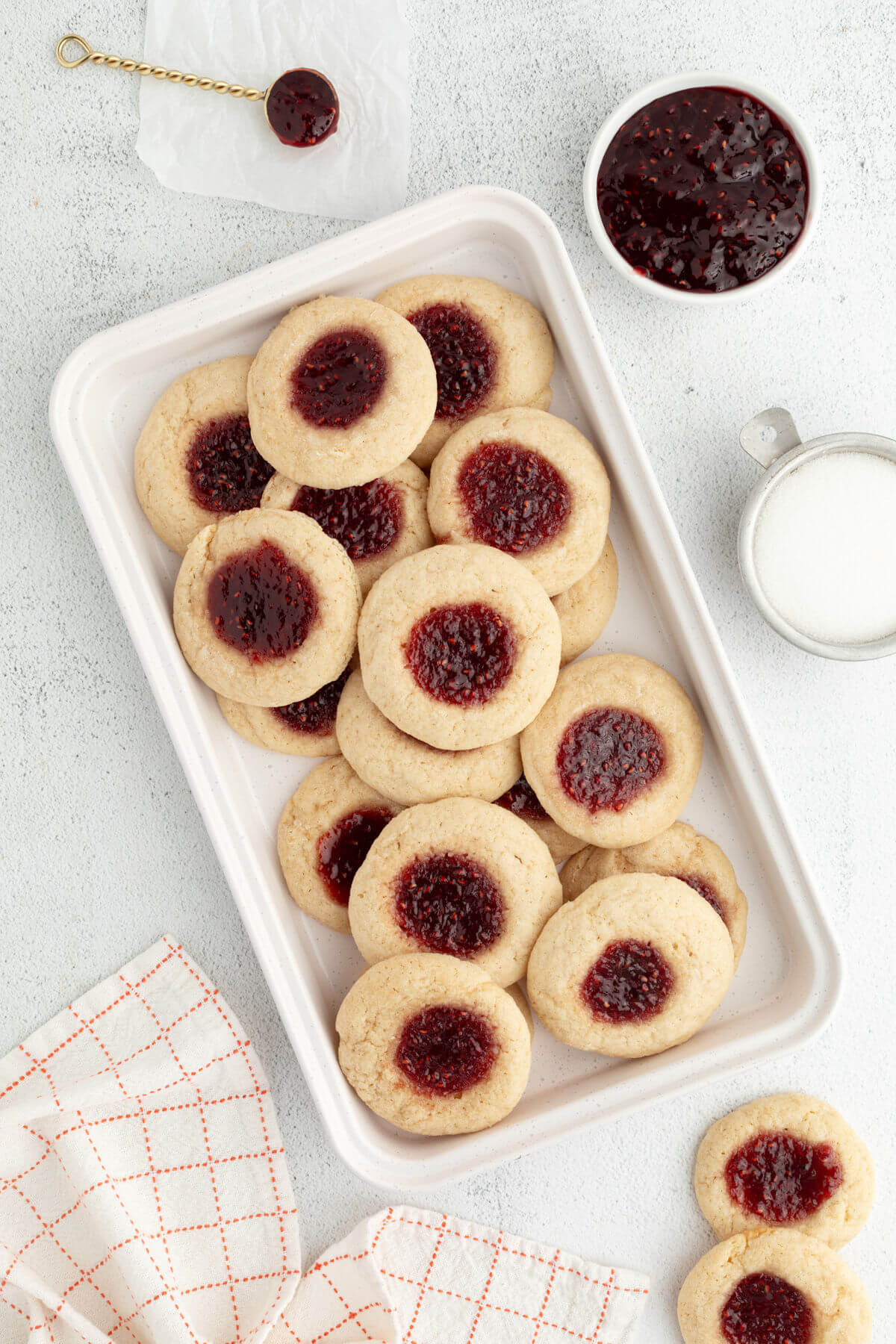 Sourdough thumbprint cookies on a white tray.