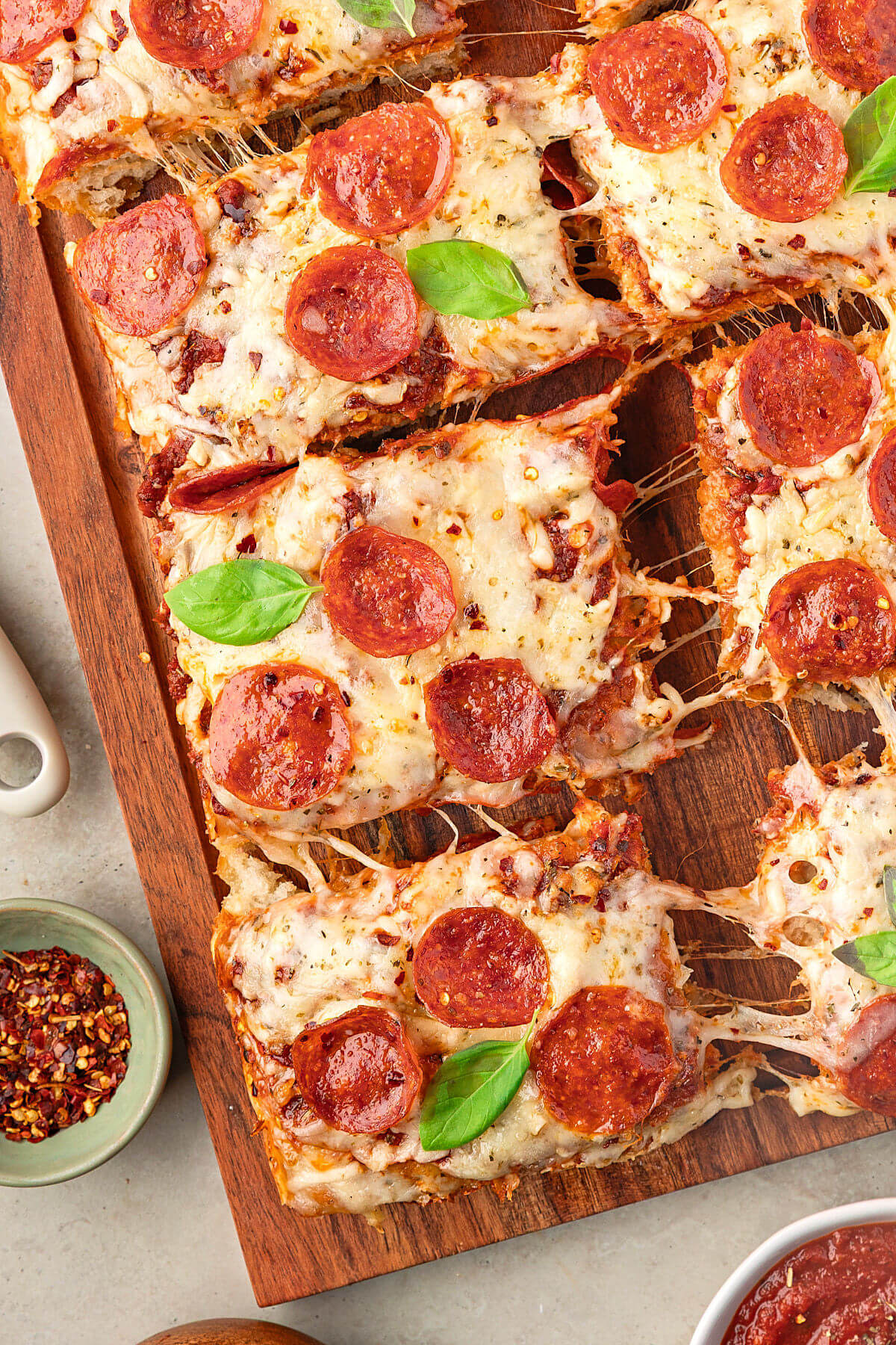 Sourdough discard focaccia pizza cut into serving pieces.
