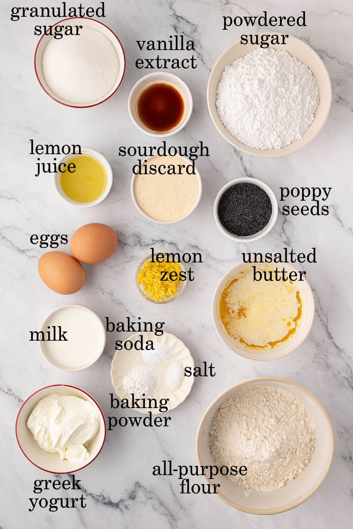 Ingredients for sourdough lemon poppy seed muffins in small bowls.