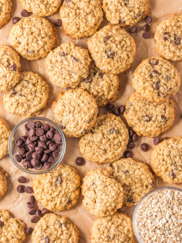 Sourdough oatmeal chocolate chip cookies on a parchment lined baking sheet.