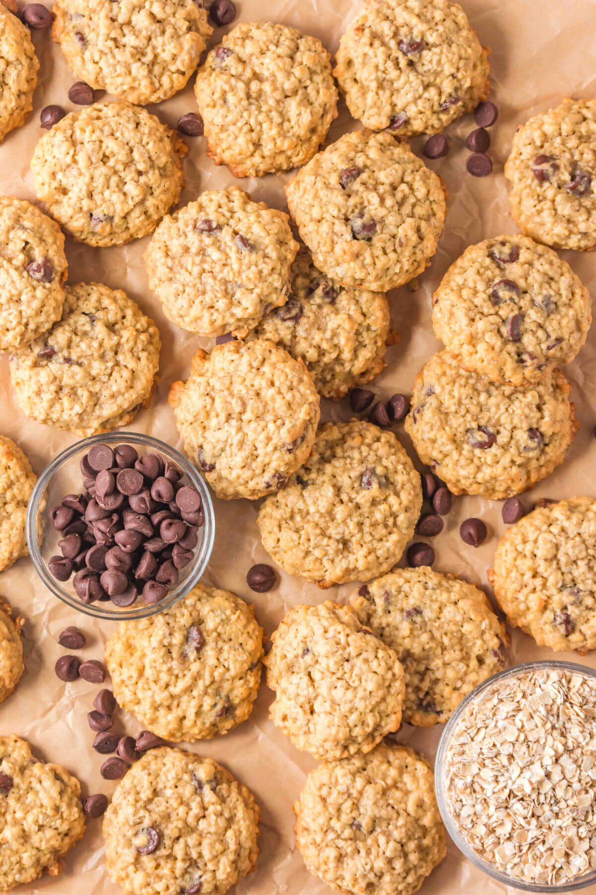 Sourdough oatmeal chocolate chip cookies on a parchment lined baking sheet.