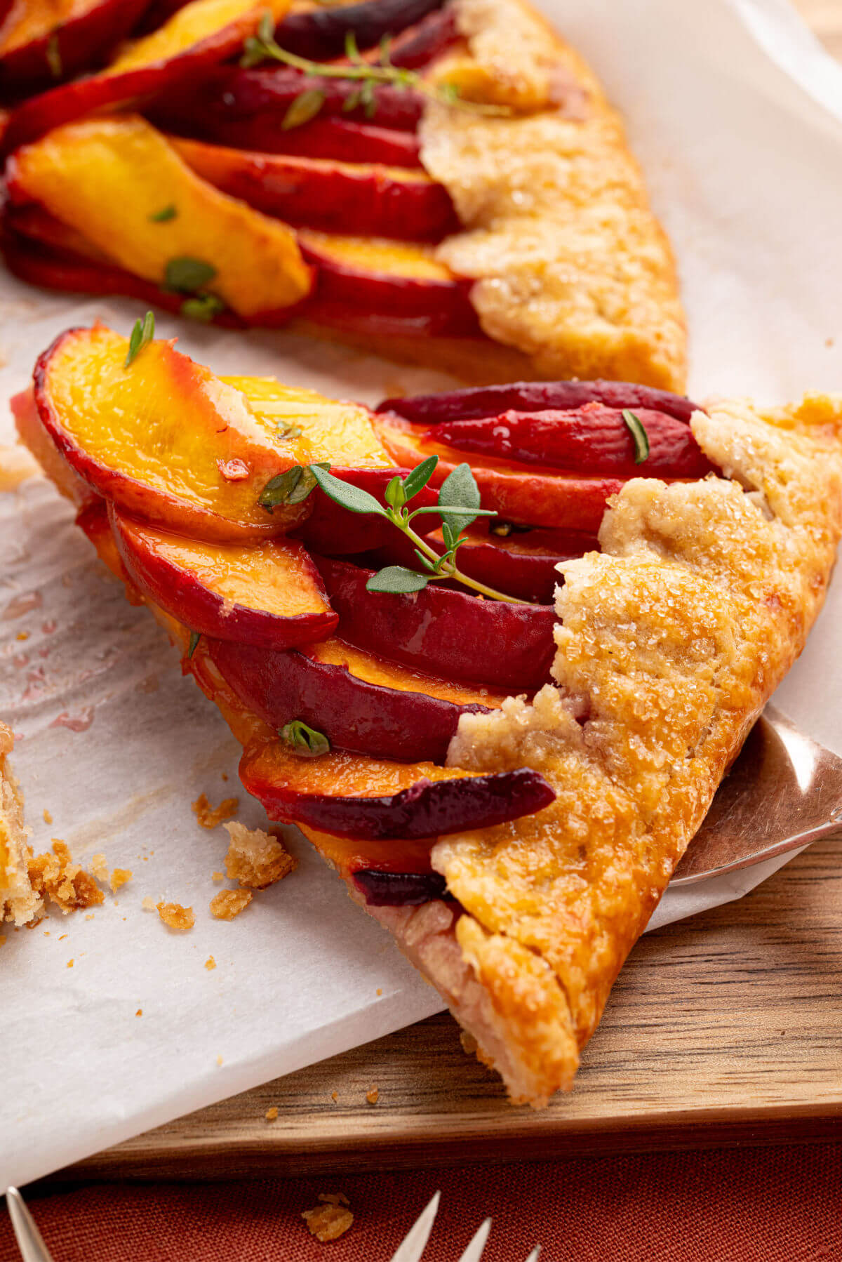 Sourdough peach galette on a serving spoon.