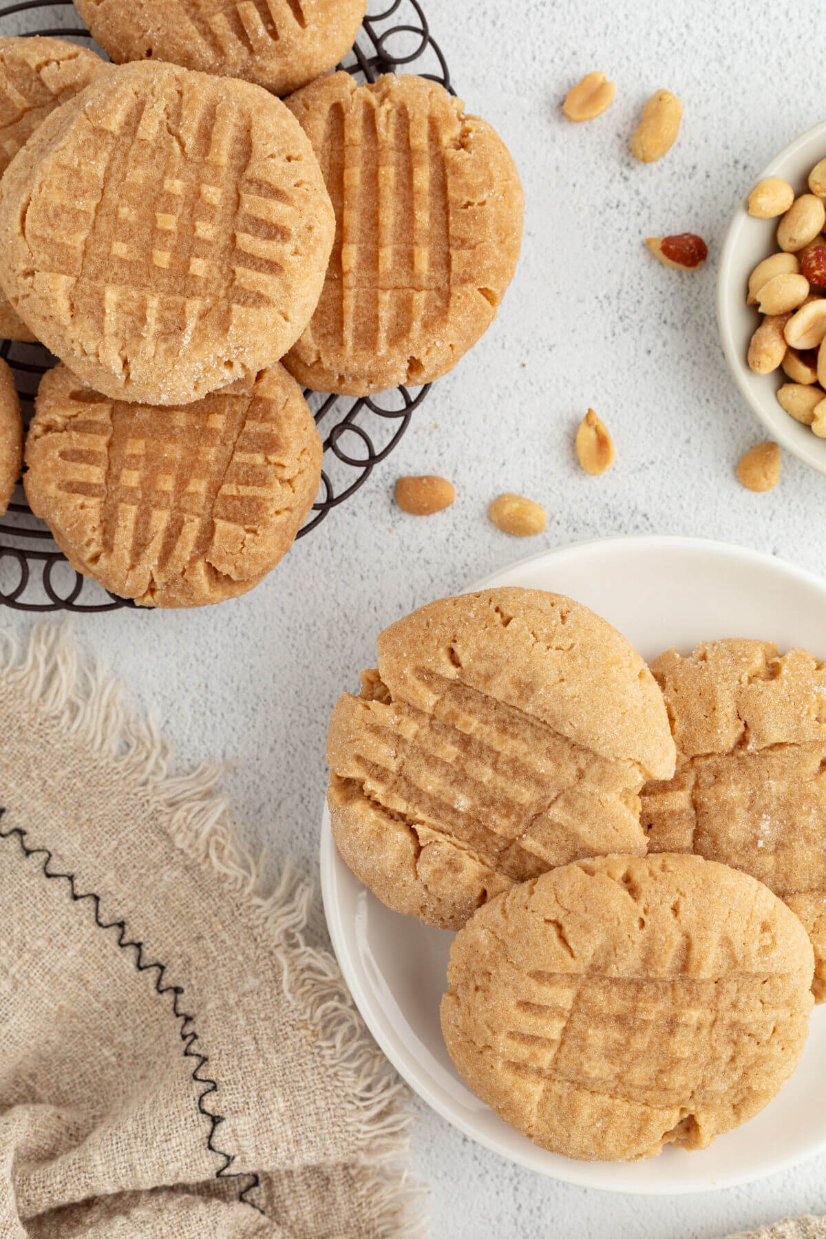 Peanut butter sourdough discard cookies on a wire rack and plate.