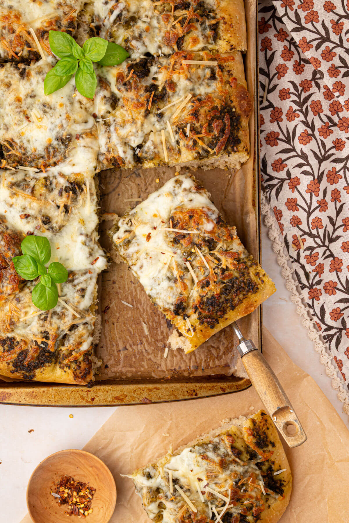 Sourdough focaccia pizza bianca on a baking sheet, cut into serving pieces.