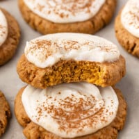 Sourdough pumpkin cookies piled on parchment paper.