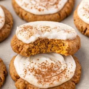 Sourdough pumpkin cookies piled on parchment paper.
