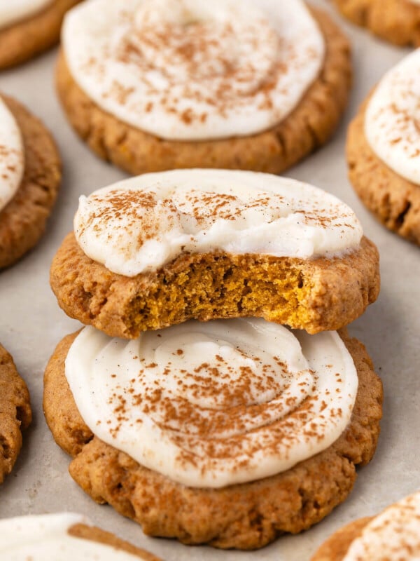 Sourdough pumpkin cookies piled on parchment paper.
