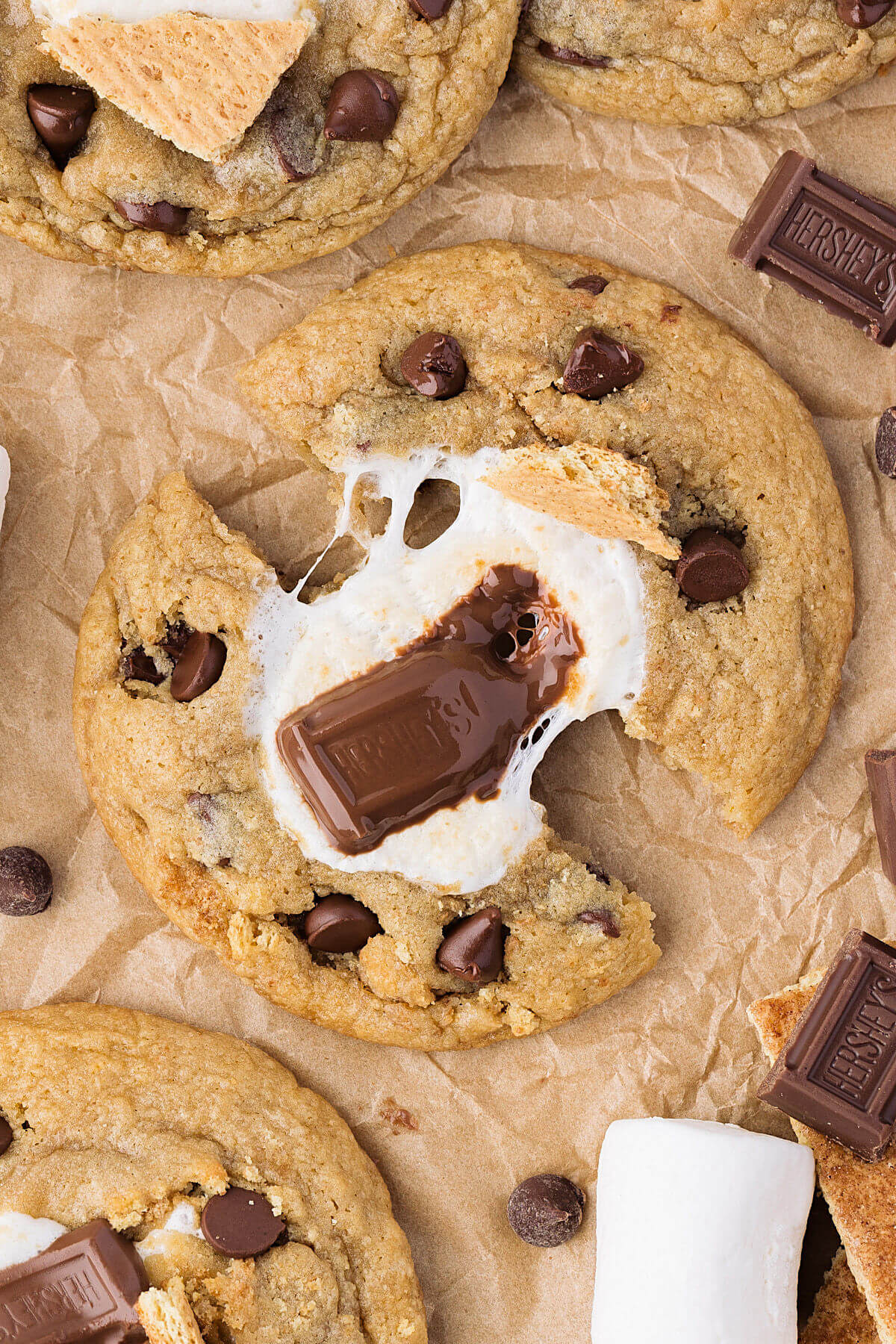 Sourdough s'mores cookies being broken in half to show melted chocolate.