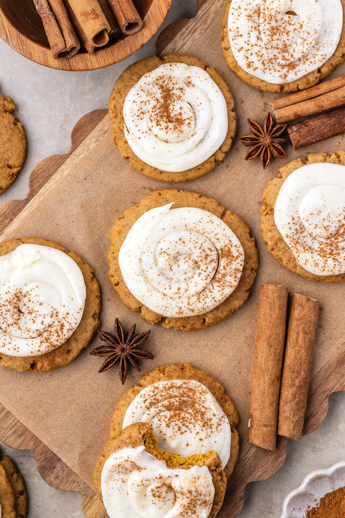 Sourdough pumpkin cookies with cream cheese frosting on a piece of parchment paper.