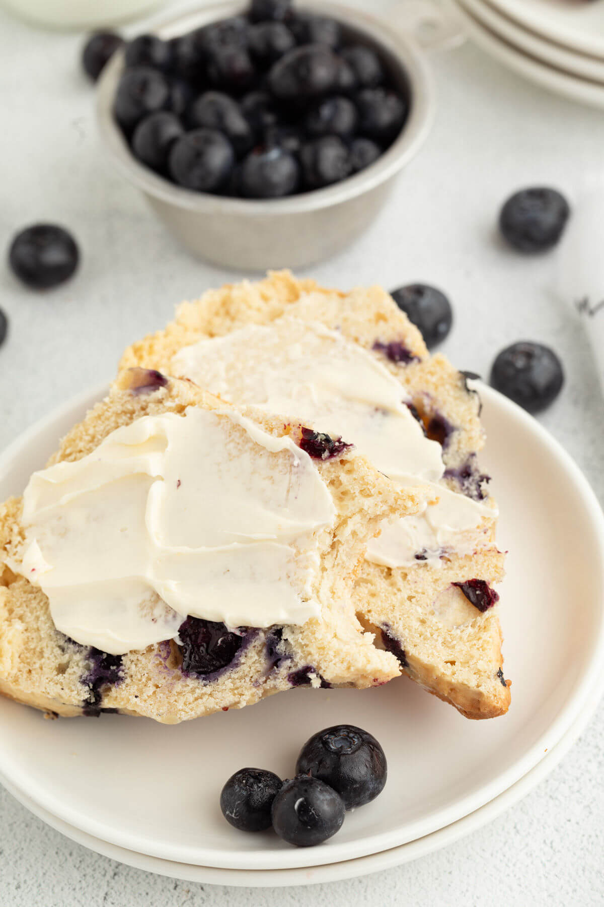 Sourdough blueberry scones topped with butter.