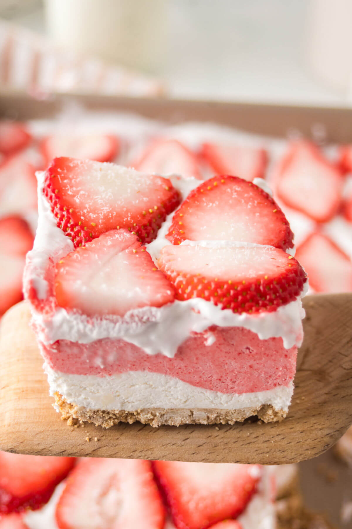Strawberry delight dessert cut into squares.