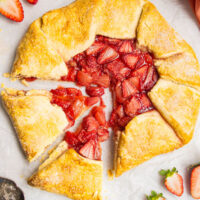 Strawberry galette with two slices cut out.