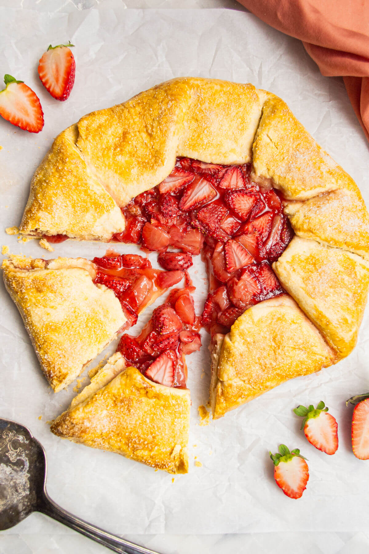 Strawberry galette with two slices cut out.