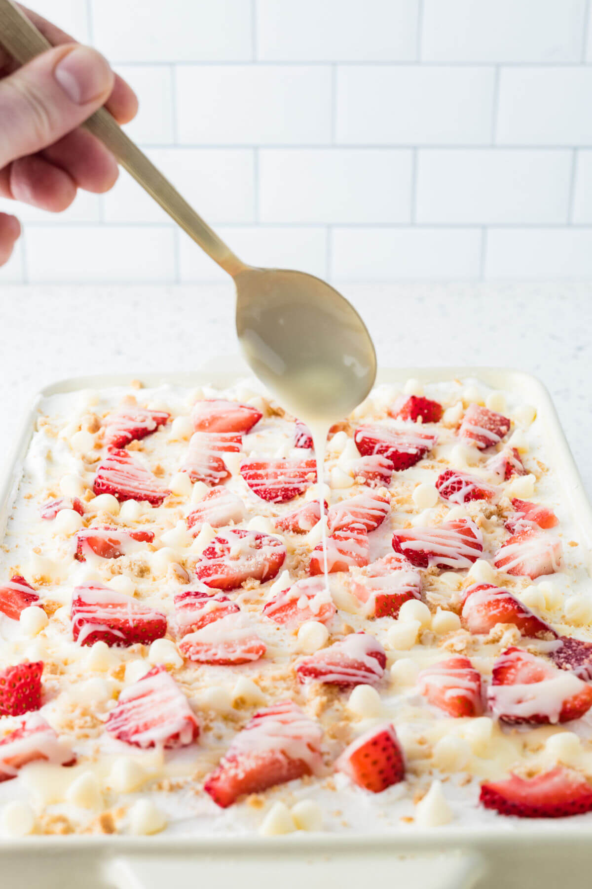 Drizzling white chocolate ganache over the strawberry icebox cake.