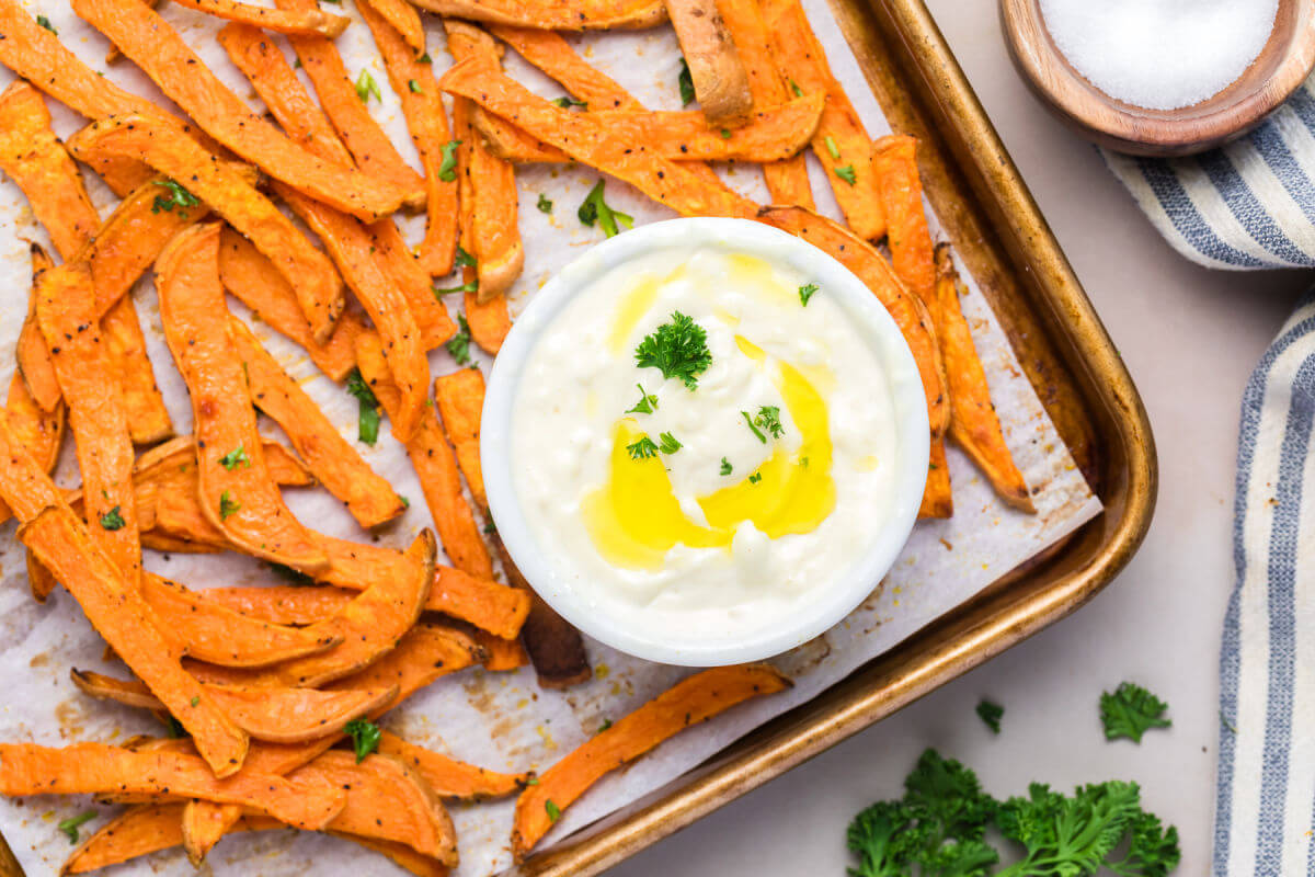 Baking sheet with crispy sweet potato fries after baking.