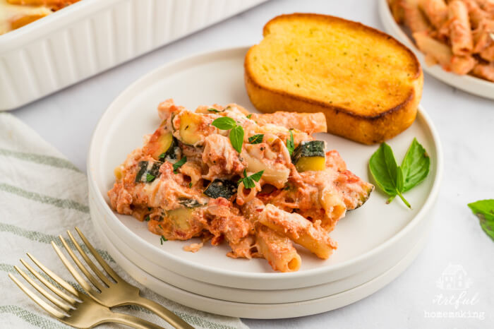 white plate of meatless baked ziti with buttered garlic on the side of the plate
